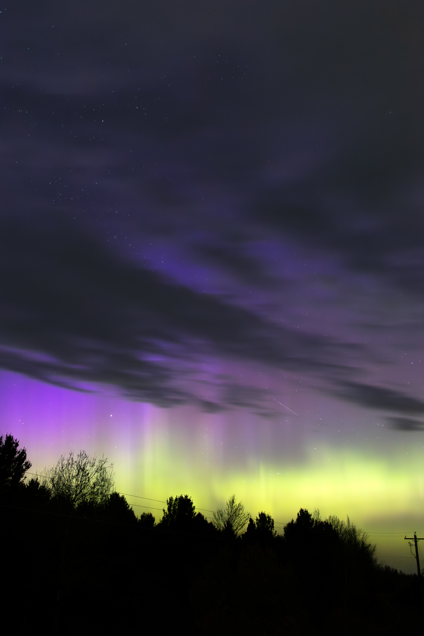 Green curtains of the aurora borealis above Lake Superior, photographed from Houghton, Michigan by Forbes Robertson.